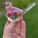 Dried flower resin bird with clear resin, pink and lilac clover blossoms, and delicate stems in the tail