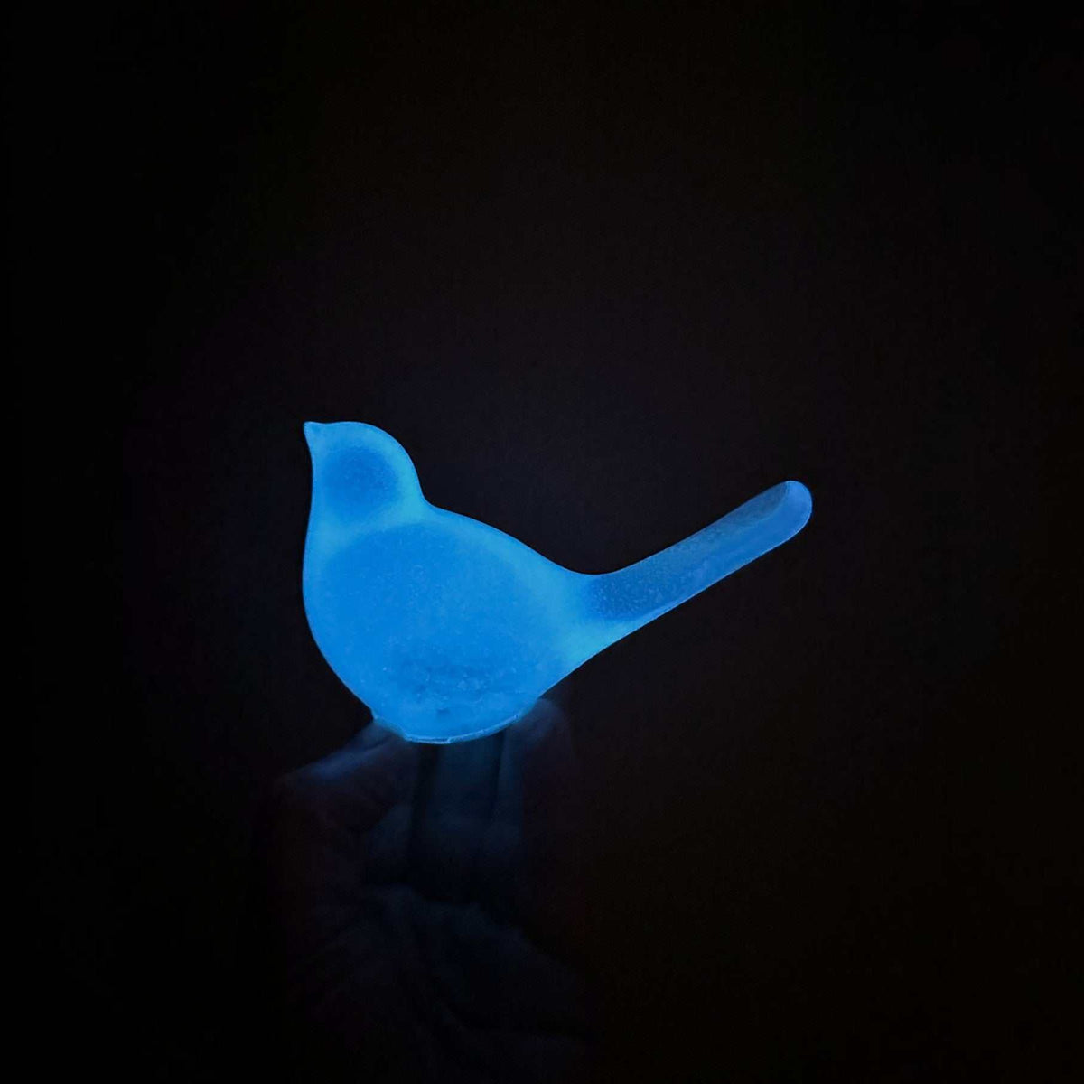 Teal glow resin bird decor, handcrafted translucent resin songbird with a softly glowing blue finish and long tail.