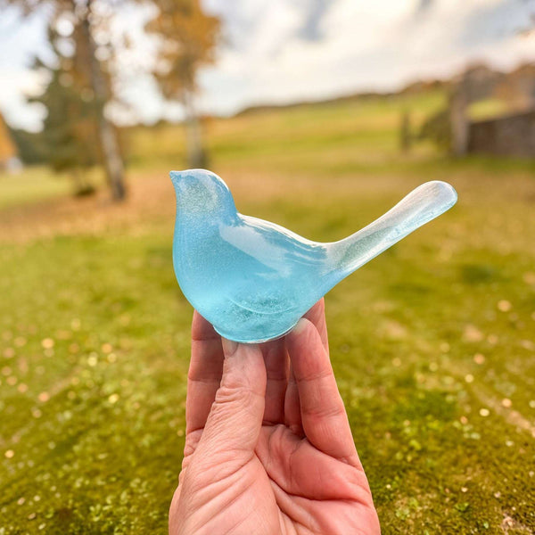 Teal glow resin bird decor, translucent aqua-blue resin songbird with a smooth curved tail and rounded body