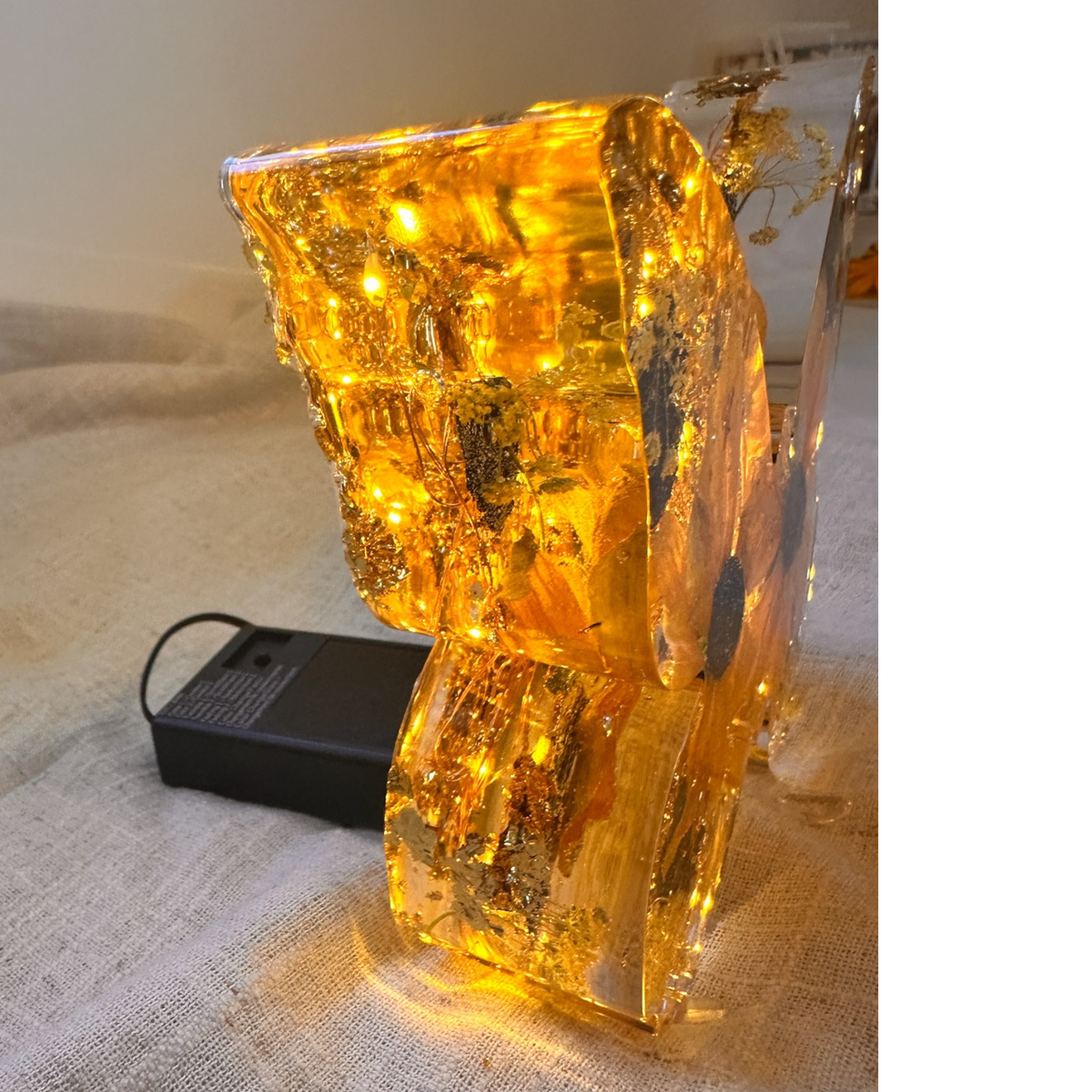 Light up resin butterfly decor with amber glow, clear resin, pressed botanicals and shimmering gold leaf details