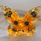 Light up resin butterfly decor featuring a clear resin butterfly with orange blooms, black centres and gold leaf accents