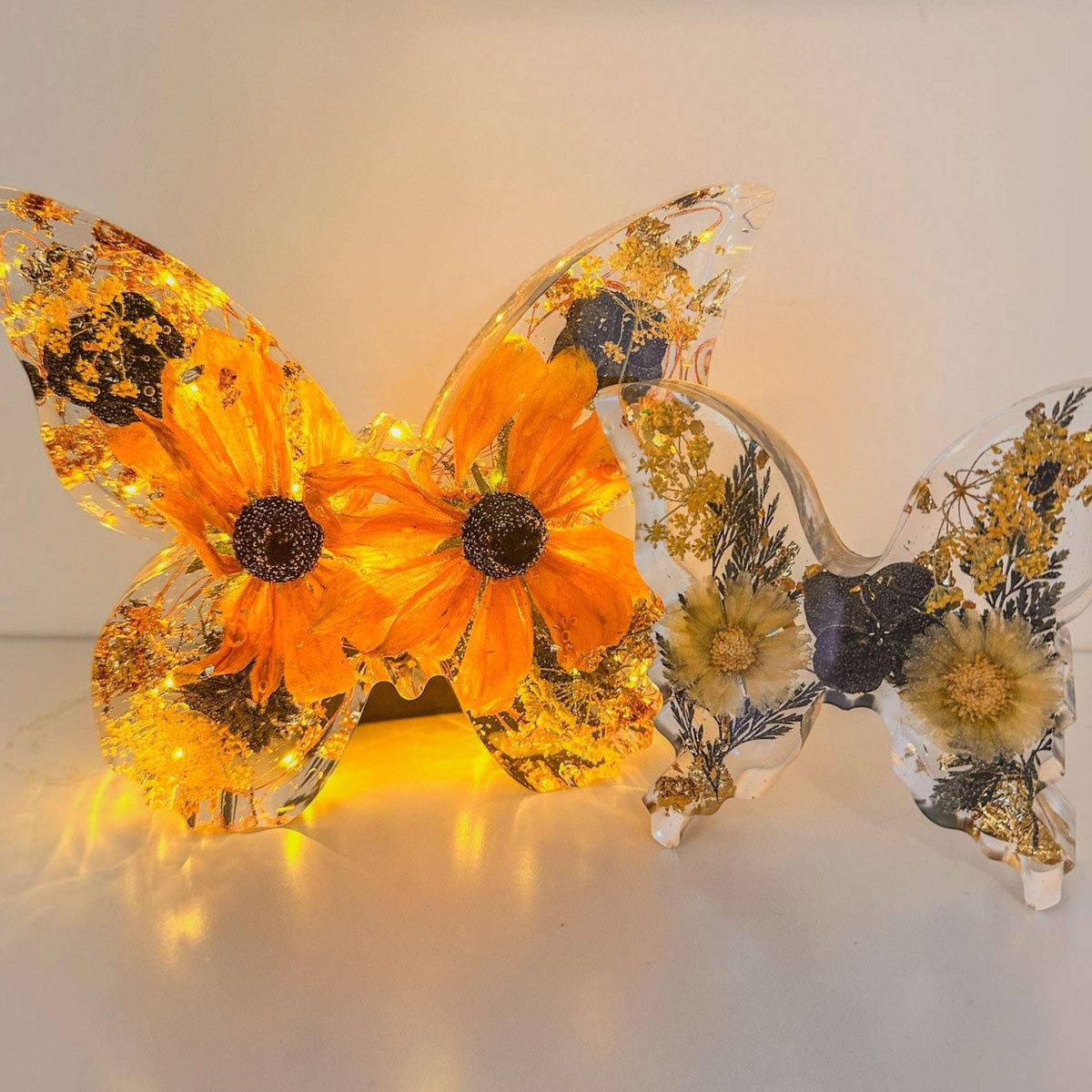 Light up resin butterfly decor set with two clear butterflies, orange flowers, pressed botanicals and gold foil, LED lit
