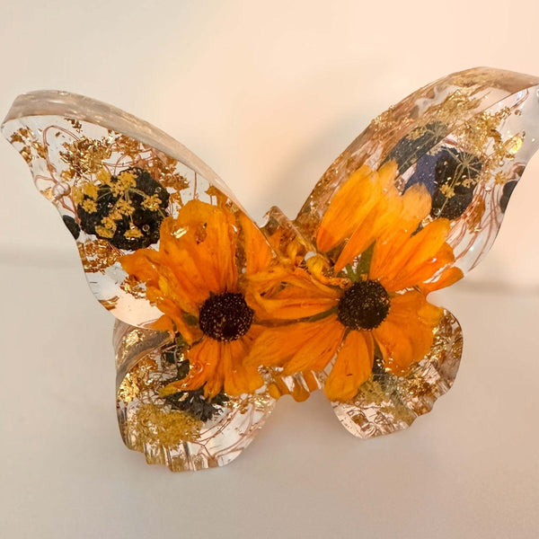 Light up resin butterfly decor featuring a clear resin butterfly with vivid orange flowers, gold leaf and black accents