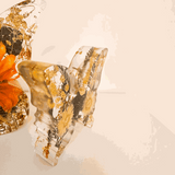 light up resin butterfly decor set in clear resin with pressed botanicals, gold leaf and warm orange floral accents, two-piece design