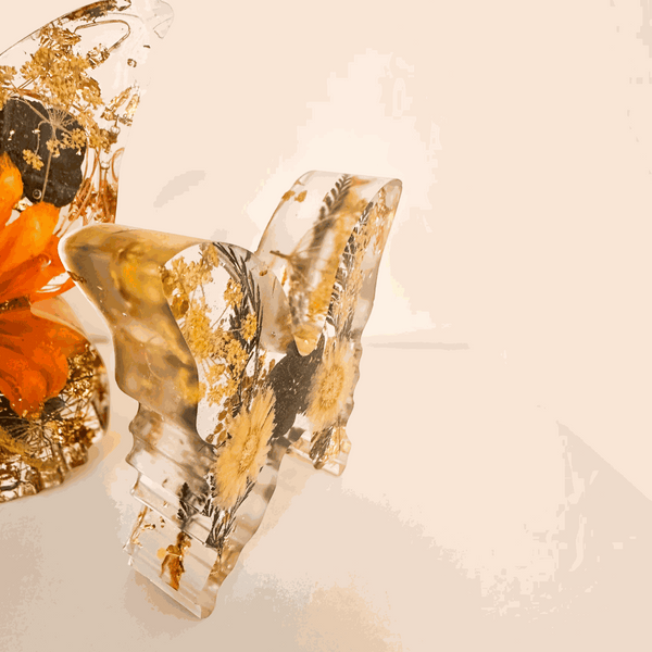 light up resin butterfly decor set in clear resin with pressed botanicals, gold leaf and warm orange floral accents, two-piece design
