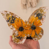 Light up resin butterfly decor featuring a clear resin butterfly with orange flowers, black centres and gold leaf accents
