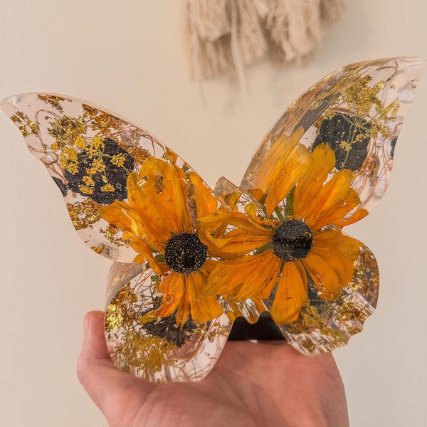 Light up resin butterfly decor featuring a clear resin butterfly with orange flowers, black centres and gold leaf accents