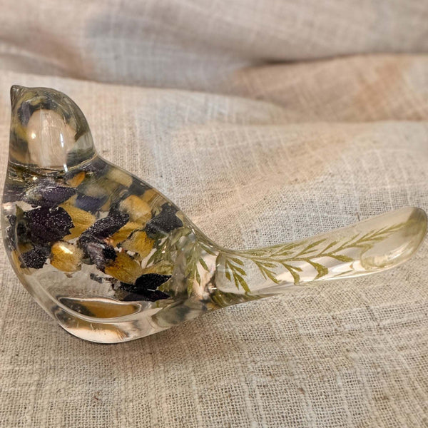 Blue Lupine resin bird decor, clear resin songbird with dark purple and golden yellow flowers and green foliage in its tail
