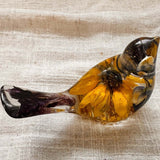 Sunflower lupine resin bird decor with clear amber resin, golden sunflower petals, dark centre and deep purple tail.
