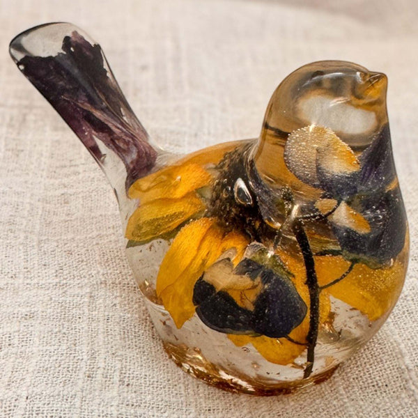 Sunflower lupine resin bird decor in clear resin, with golden petals, dark purple blooms, and gold flecks at the base.