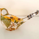 Sunflower Songbird decor in clear resin, with yellow flowers, green leaves, and a long transparent tail with dark inclusions.