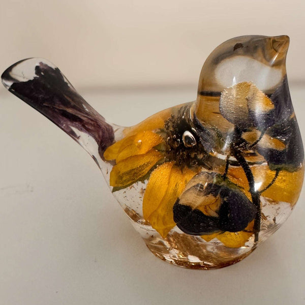 Sunflower lupine resin bird decor with clear resin, golden sunflower petals, dark center, purple blooms, and plum tail accents.