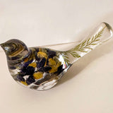 Blue Lupine resin bird decor in clear resin, with deep blue and golden yellow flowers and green botanicals in its tail.
