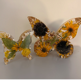 Light up resin butterfly decor set with two clear resin butterflies, pressed yellow flowers, green leaves and gold accents