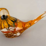 Resin bird with a preserved yellow black-eyed Susan and gold accents, Golden Meadow botanical decor with a glossy finish
