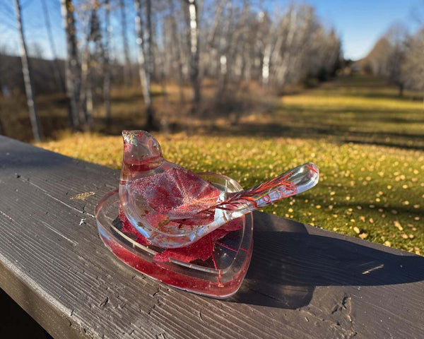 Maple leaf bird and tray set of clear glossy resin, featuring embedded red leaves, gold flecks and a bird-shaped dish.