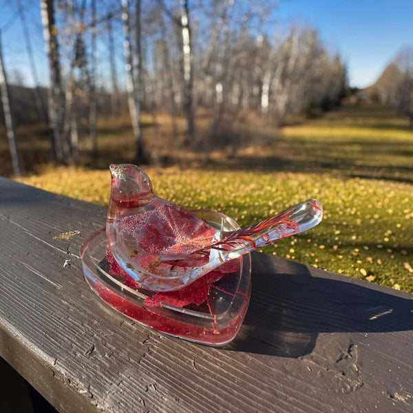 Maple leaf bird and tray set of clear glossy resin, featuring embedded red leaves, gold flecks and a bird-shaped dish.