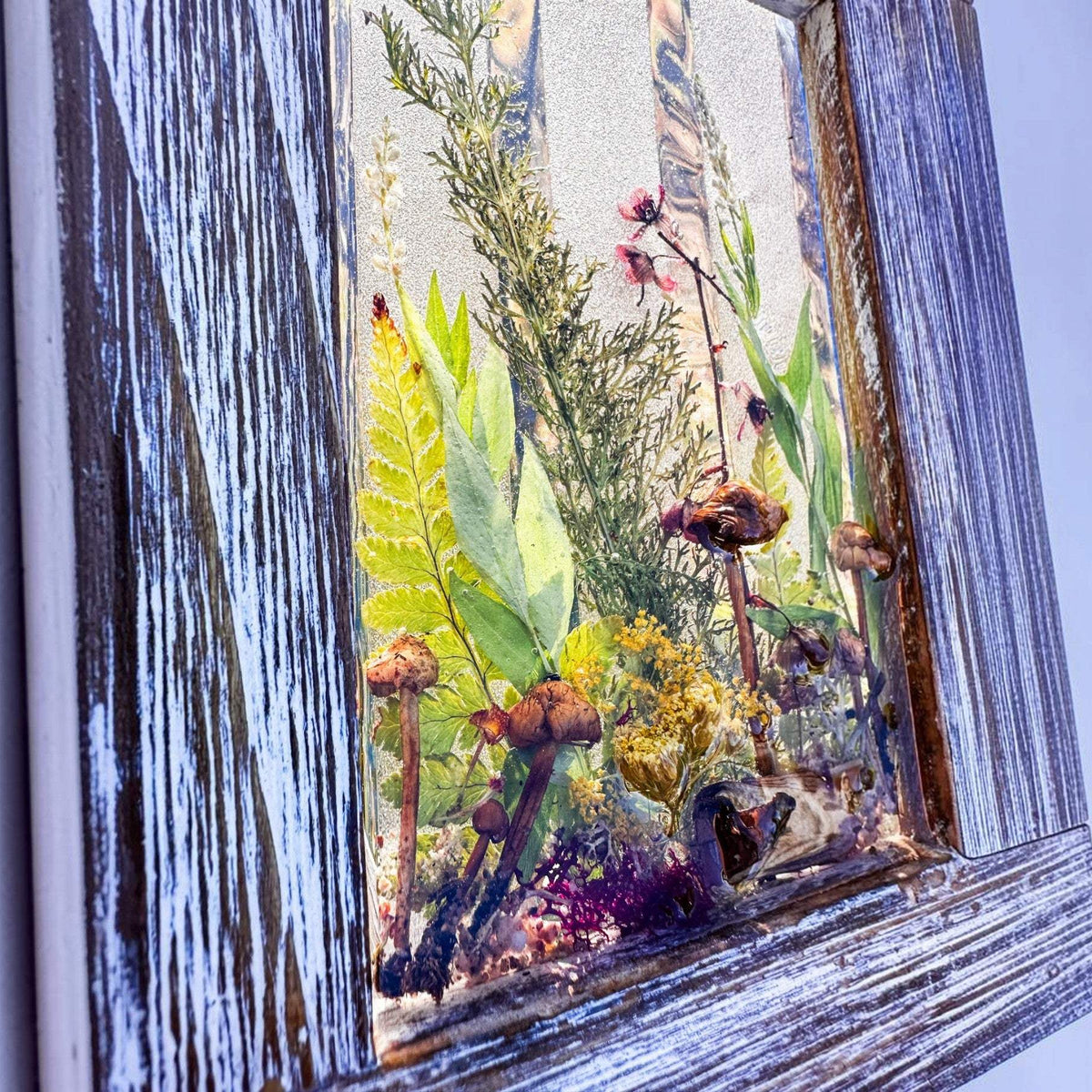 Boreal forest window art hanging on a wall, 15 inches tall