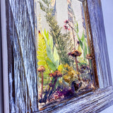 Boreal forest window art hanging on a wall, 15 inches tall