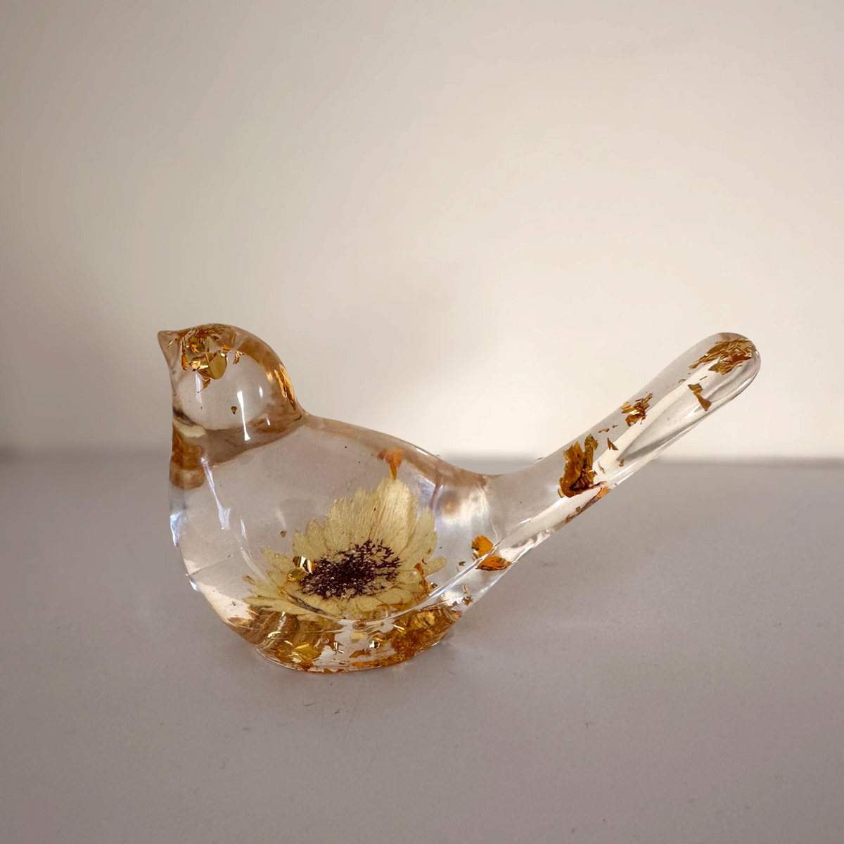 Handmade gold leaf resin bird from Cold Lake Alberta measuring 4 inches long