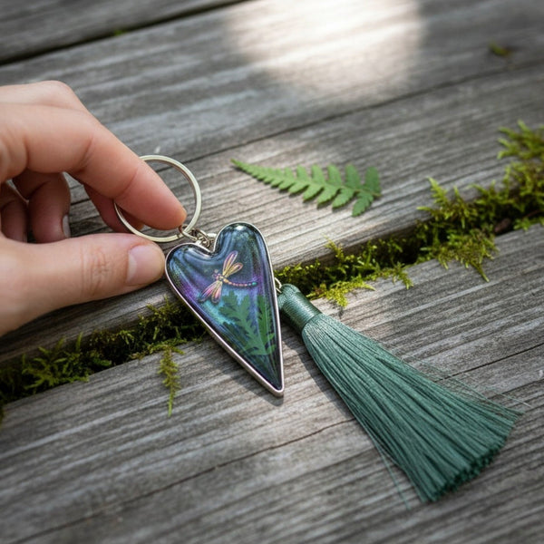 Aurora dragonfly keychain in a silver heart frame, glossy green-purple resin with fern and dragonfly, green tassel.