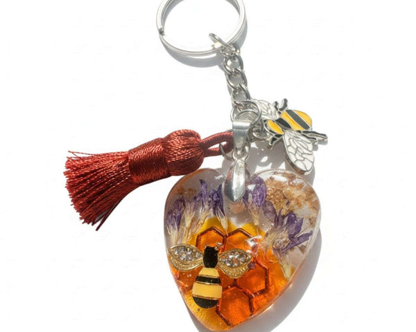 Honeybee Heart Bag Charm with rhinestone bee, pressed purple flowers, golden honeycomb, enamel bee charm, and copper tassel on silver keychain ring