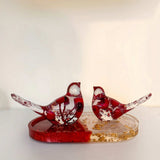 Close up of a berry resin bird set showing bright red berries and red sparkle