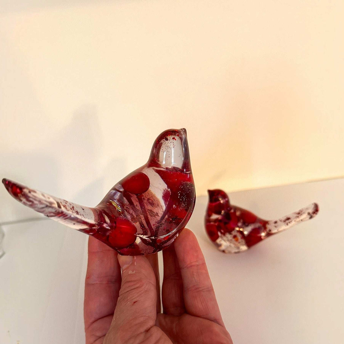 Berry resin bird set showing the larger bird with red berries inside clear resin