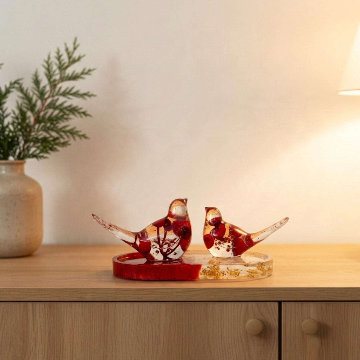 Berry resin bird set styled on a table as handmade red and gold home decor