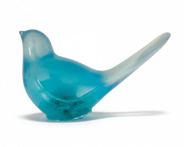 Teal glow resin bird decor, translucent teal resin songbird with a long raised tail and subtle suspended botanicals