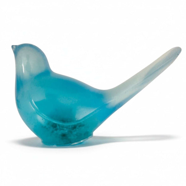 Teal glow resin bird decor, translucent teal resin songbird with a long raised tail and subtle suspended botanicals