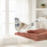 Handmade whimsical Fairy Dust bird with real forget-me-not flowers and iridescent shimmer in clear resin display
