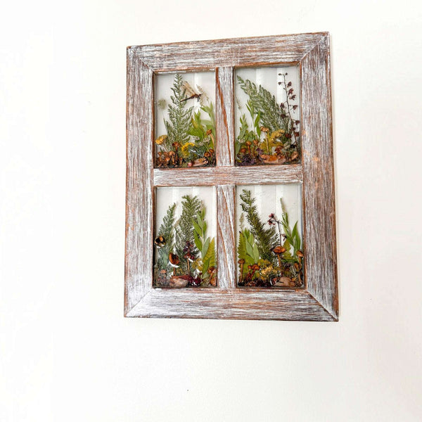 Boreal forest window art with foraged ferns, mushrooms and moss in four panes