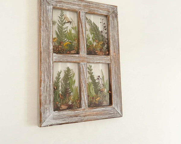 Boreal forest window art in a whitewashed wood frame with ferns and mushrooms