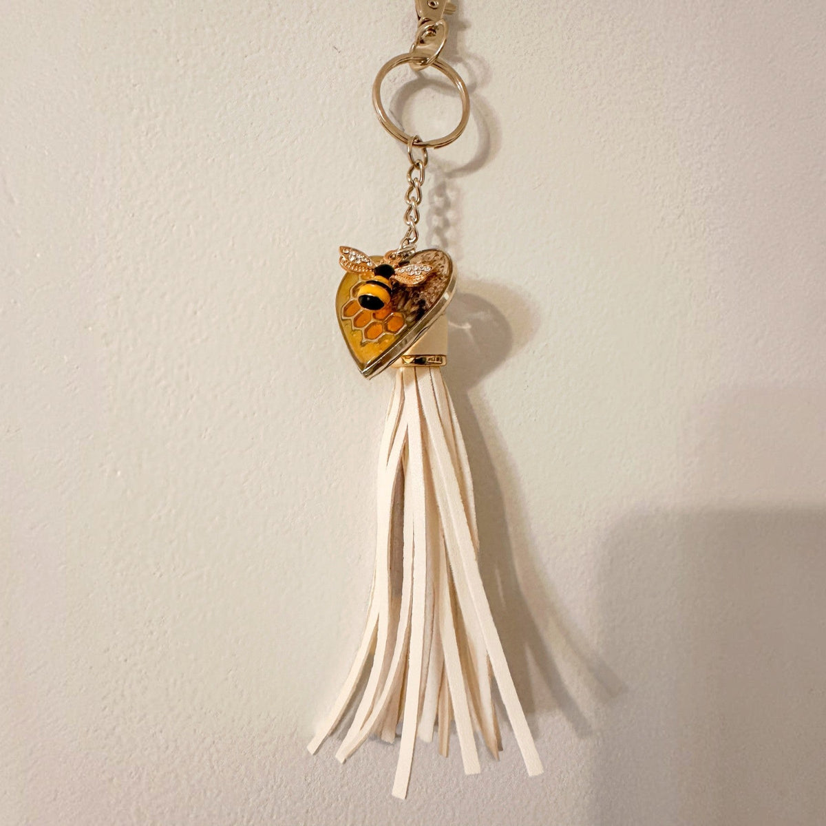 bumble bee resin keychain with an amber honeycomb heart, small bee detail and long cream tassel