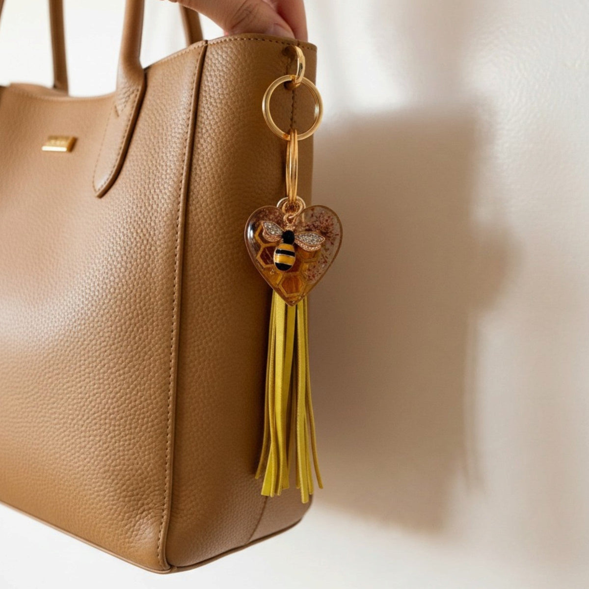 bumble bee resin keychain with an amber heart, pressed flowers, bee charm and long golden yellow tassel