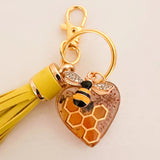 Gold bumble bee resin keychain with an amber honeycomb heart, bee charm and mustard tassel