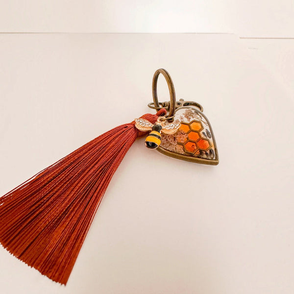 Antique bronze bumble bee resin keychain with an amber honeycomb heart, bee charm and silk tassel