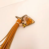 Bumble bee resin keychain with amber honeycomb heart, pressed flowers, crystal-wing bee charm and tan tassel
