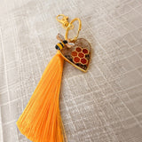 bumble bee resin keychain with a gold heart, amber honeycomb, bee charm and long orange tassel