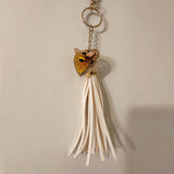 bumble bee resin keychain with a honey-gold heart, bee motif and long ivory tassel on a gold-tone ring