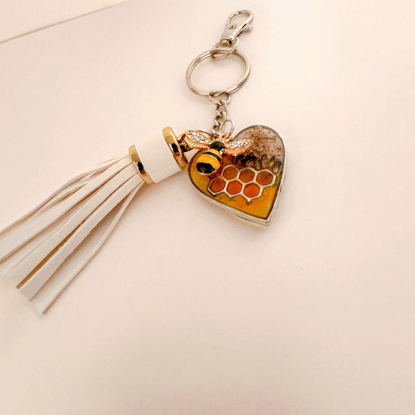 bumble bee resin keychain with a honey-gold heart, honeycomb detail, dried flowers, bee charm and white tassel