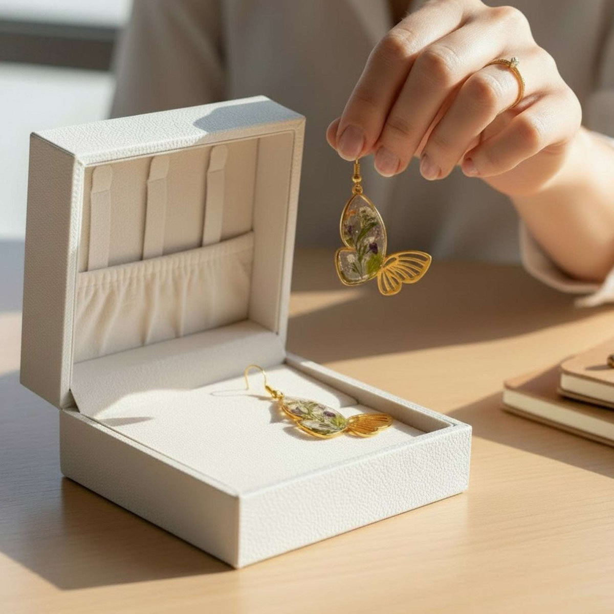 Handmade Fluttering Blossom earrings with real pressed flowers in resin butterfly wings and delicate butterfly accents