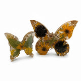 Resin butterfly decor set, light up resin butterfly decor with clear wings, yellow flowers, green leaves, and gold flecks.