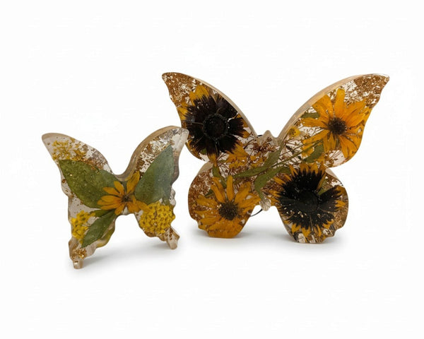 Resin butterfly decor set, light up resin butterfly decor with clear wings, yellow flowers, green leaves, and gold flecks.
