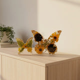 Light up resin butterfly decor set with two clear resin butterflies, amber and yellow dried flowers, green leaves and gold accents