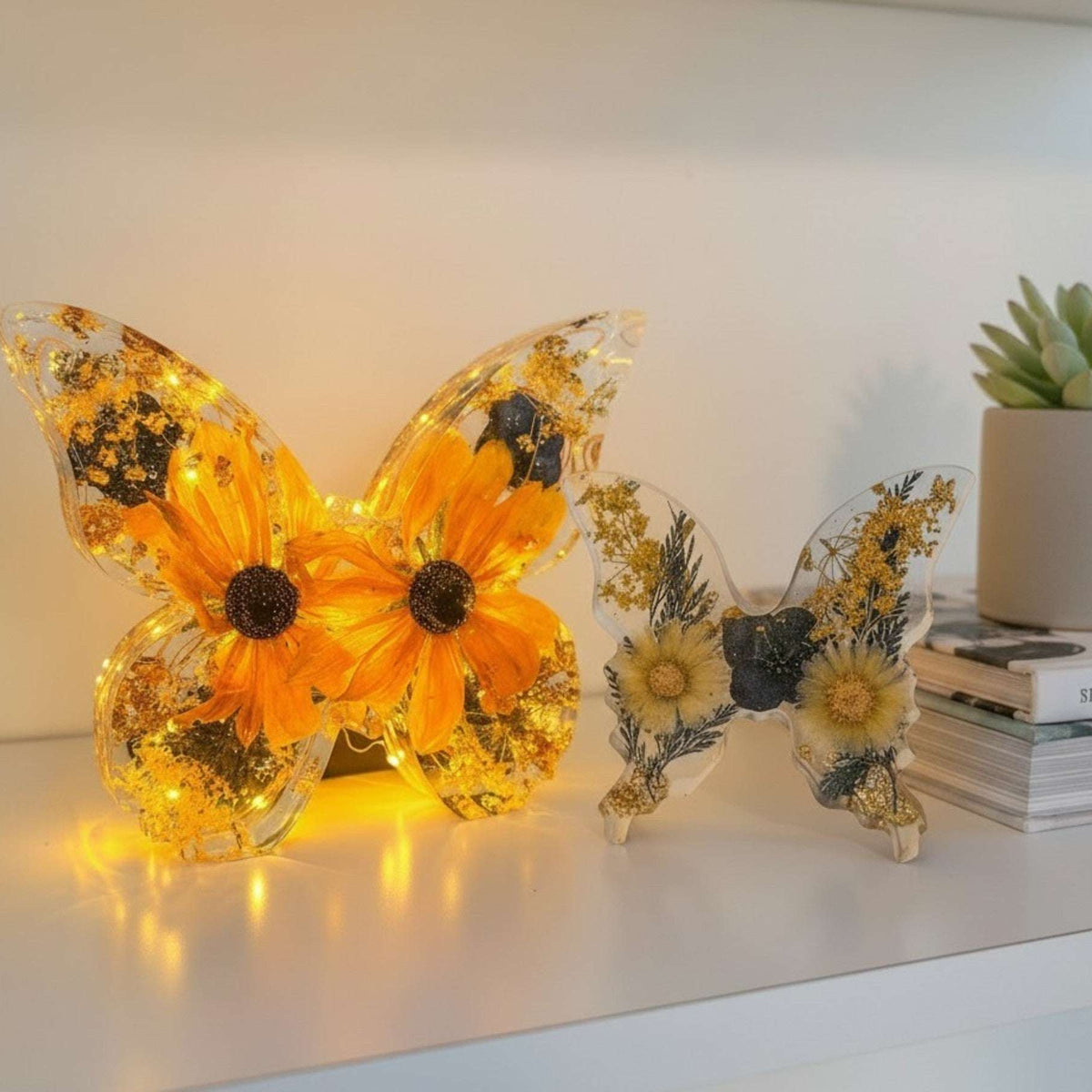 Light up resin butterfly decor set with clear resin, glowing orange flowers, pressed botanicals, and gold leaf accents