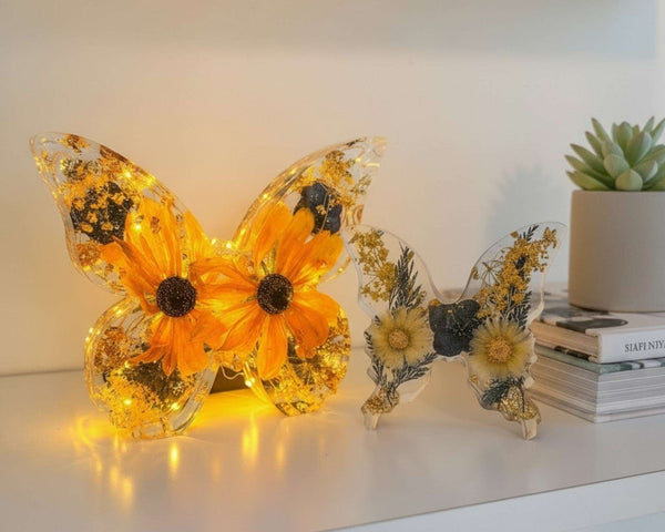 Light up resin butterfly decor set with clear resin, glowing orange flowers, pressed botanicals, and gold leaf accents