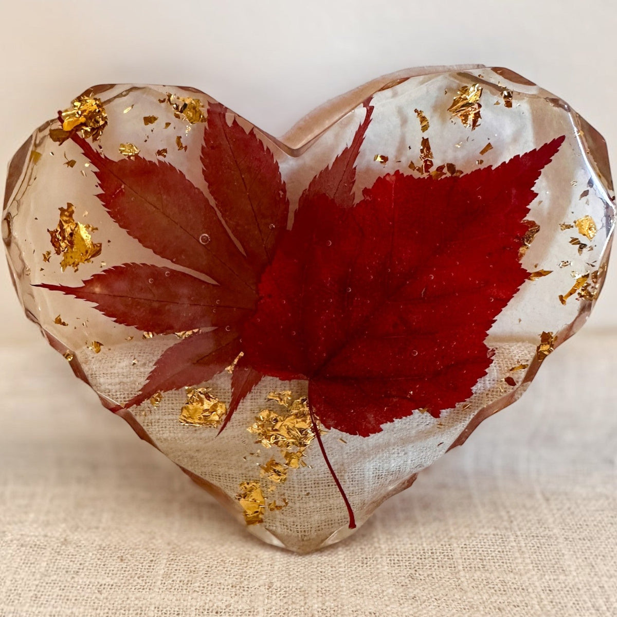 Maple leaf heart resin coaster with gold leaf shimmer through the background
