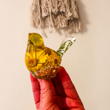 yellow canary resin bird with real yellow daisies, green foliage, and gold leaf base, handmade in Alberta